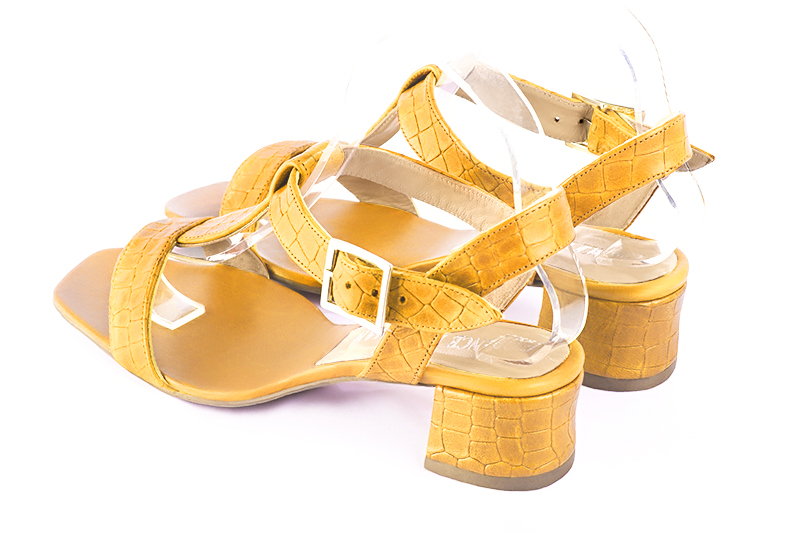 Mustard yellow women's fully open sandals, with an instep strap. Square toe. Low flare heels. Rear view - Florence KOOIJMAN